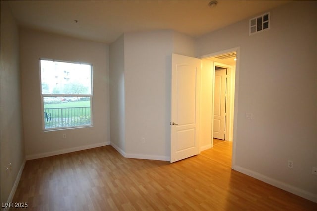 62 E Serene Ave Unit 129, Las Vegas, NV 89123 - unfurnished room with light wood-style floors, baseboards, and a smoke detector