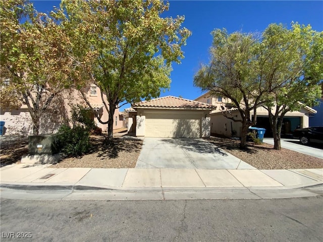 5474 Jacobs Field St, Las Vegas, NV 89148 - view of front of home featuring an attached garage, a tiled roof, stucco siding, and driveway