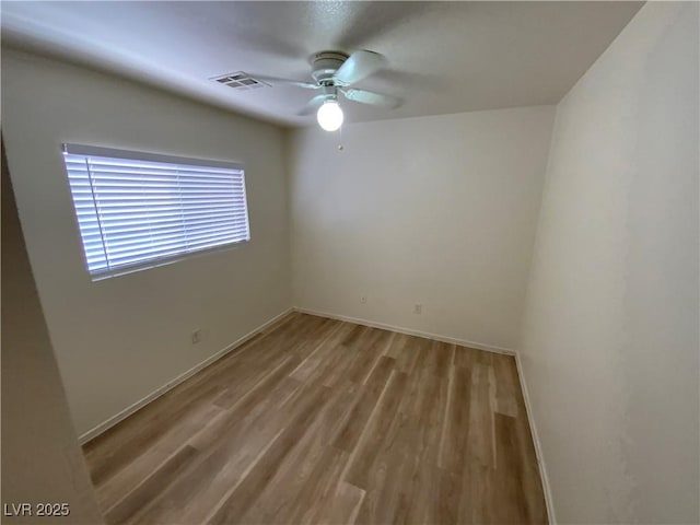 5474 Jacobs Field St, Las Vegas, NV 89148 - spare room with a ceiling fan, light wood-style floors, and baseboards