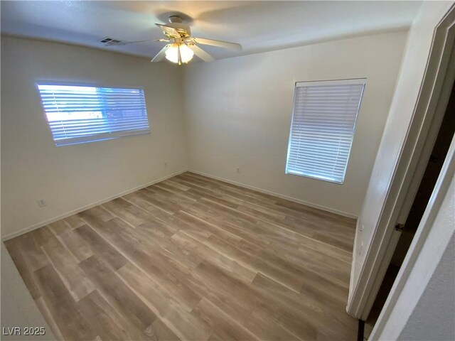 5474 Jacobs Field St, Las Vegas, NV 89148 - spare room with a ceiling fan, wood finished floors, and baseboards