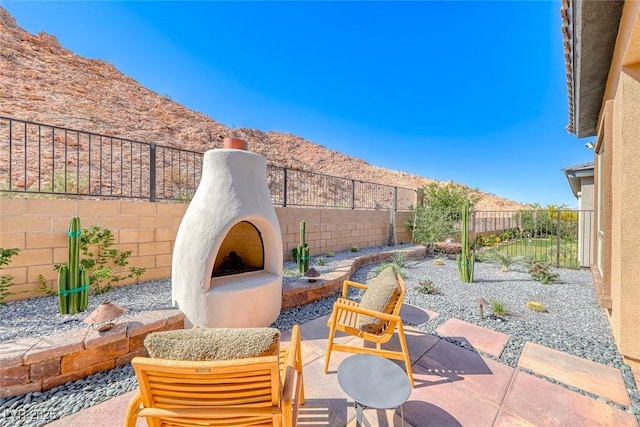 125 Mirage View Dr, Henderson, NV 89011 - view of patio featuring a mountain view and a fenced backyard