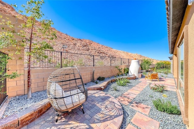 125 Mirage View Dr, Henderson, NV 89011 - view of patio / terrace featuring a mountain view and a fenced backyard