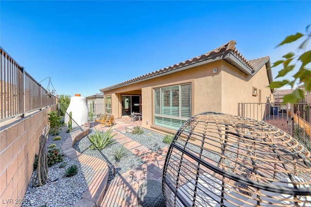 125 Mirage View Dr, Henderson, NV 89011 - back of house featuring stucco siding, a patio, a fenced backyard, and a tile roof