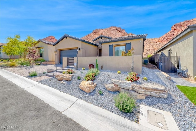 125 Mirage View Dr, Henderson, NV 89011 - mediterranean / spanish-style home featuring stucco siding, an attached garage, and a tile roof