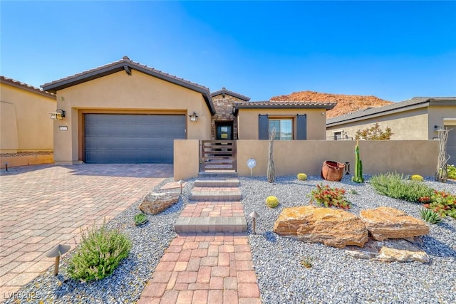 125 Mirage View Dr, Henderson, NV 89011 - mediterranean / spanish house featuring stucco siding, a garage, fence, driveway, and a tiled roof