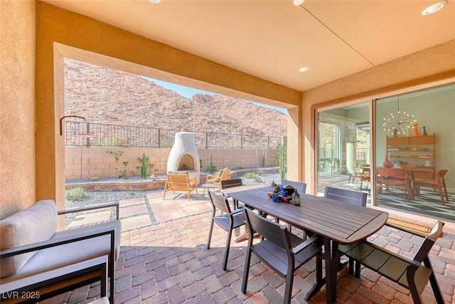 125 Mirage View Dr, Henderson, NV 89011 - view of patio with a mountain view, fence, and outdoor dining area