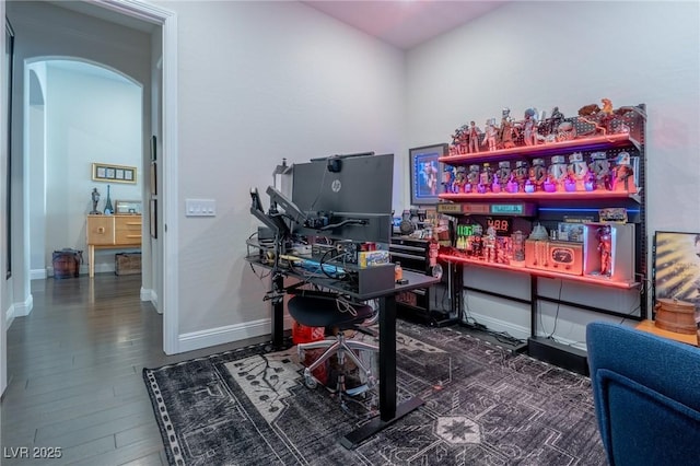 125 Mirage View Dr, Henderson, NV 89011 - office area featuring arched walkways, baseboards, wood finished floors, and a dry bar