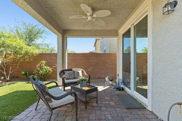 view of patio featuring fence, a ceiling fan, and outdoor lounge area
