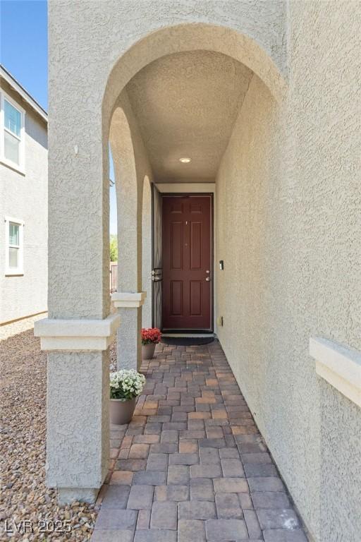 entrance to property with stucco siding