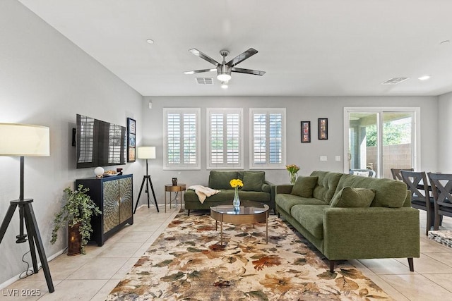 living area featuring light tile patterned floors, ceiling fan, baseboards, and recessed lighting
