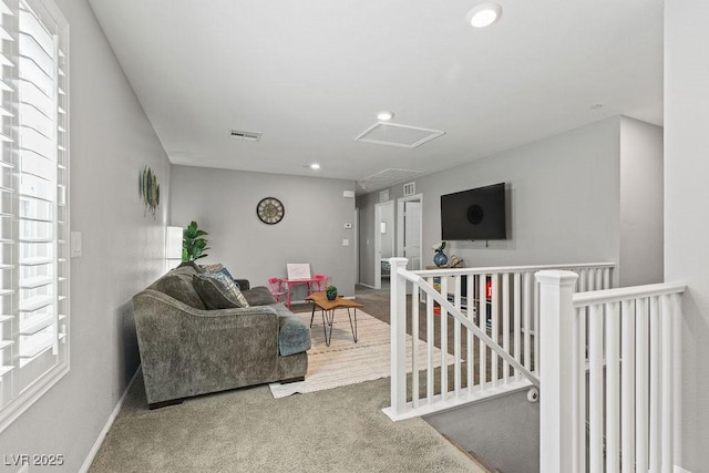 living room with attic access, carpet floors, recessed lighting, and baseboards