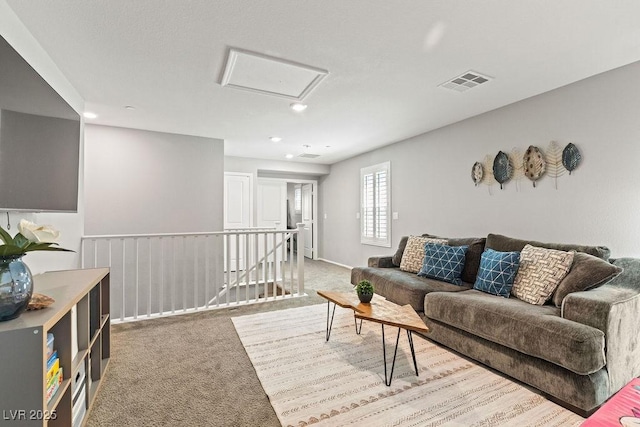 living room featuring attic access, carpet floors, and recessed lighting