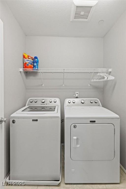 washroom with washer and dryer