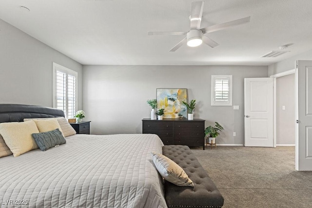 bedroom with multiple windows, carpet floors, baseboards, and ceiling fan