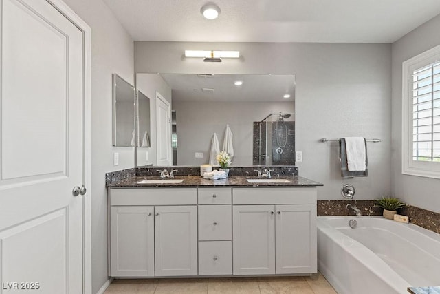 full bathroom with a shower stall, a bath, double vanity, and tile patterned flooring