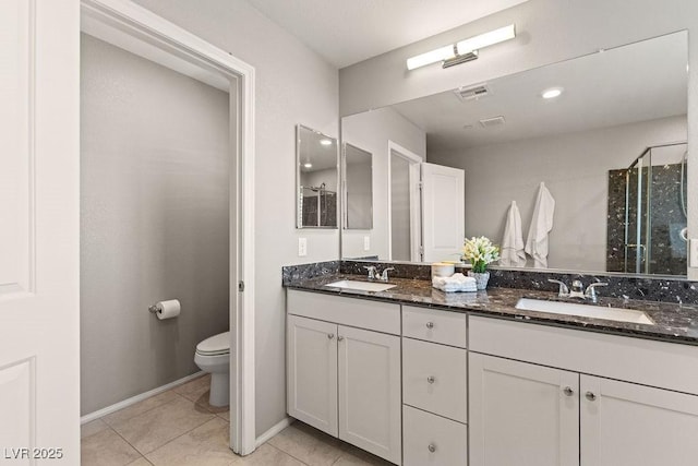 full bathroom featuring toilet, tile patterned flooring, double vanity, a stall shower, and baseboards