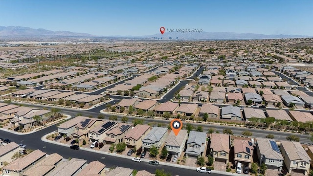 aerial view of property and surrounding area with nearby suburban area and a mountainous background