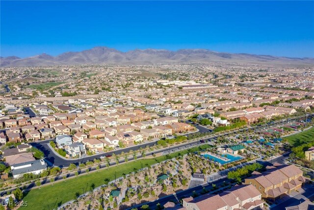 aerial overview of property's location with a mountain backdrop and nearby suburban area