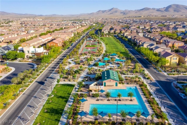 aerial view of residential area with a pool and mountains