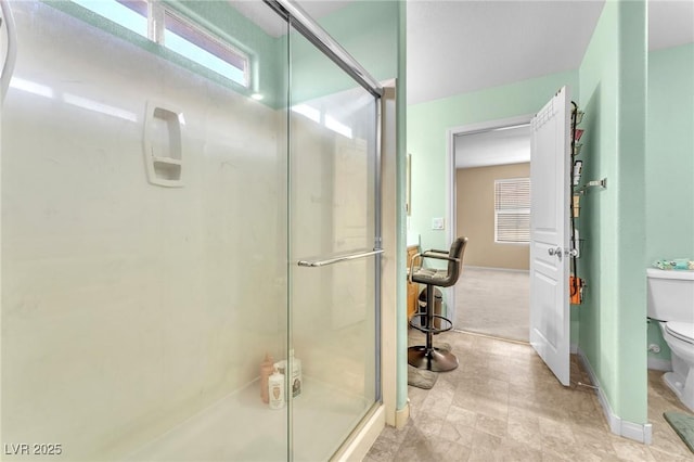 7115 Hickory Post Ave, Las Vegas, NV 89179 - full bathroom with toilet, a stall shower, and baseboards