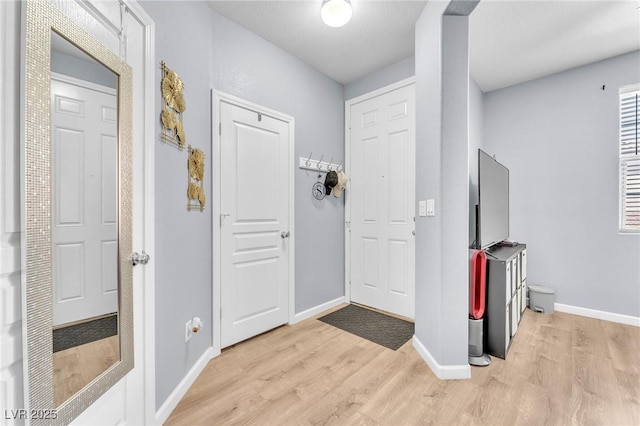 7115 Hickory Post Ave, Las Vegas, NV 89179 - foyer with light wood-type flooring and baseboards