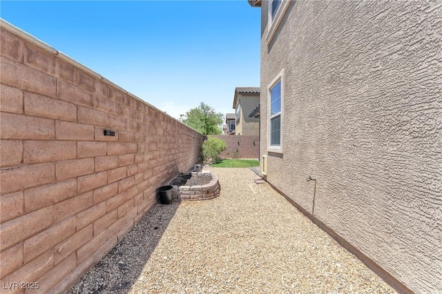 7115 Hickory Post Ave, Las Vegas, NV 89179 - view of side of property featuring a fenced backyard and stucco siding