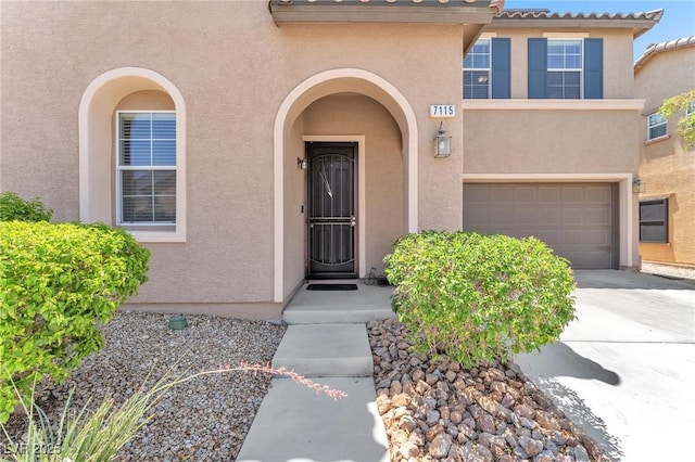 7115 Hickory Post Ave, Las Vegas, NV 89179 - doorway to property featuring stucco siding, a garage, and concrete driveway