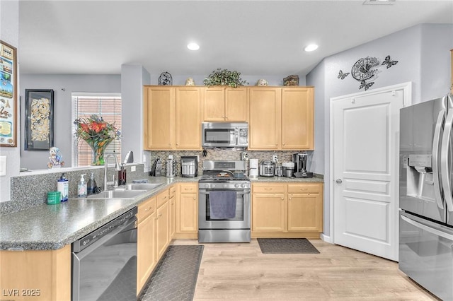 7115 Hickory Post Ave, Las Vegas, NV 89179 - kitchen with appliances with stainless steel finishes, light brown cabinets, a sink, light wood-style floors, and decorative backsplash
