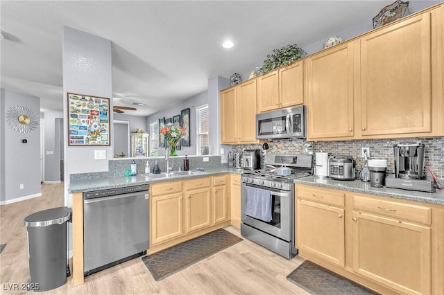 7115 Hickory Post Ave, Las Vegas, NV 89179 - kitchen featuring appliances with stainless steel finishes, light brown cabinets, and a sink