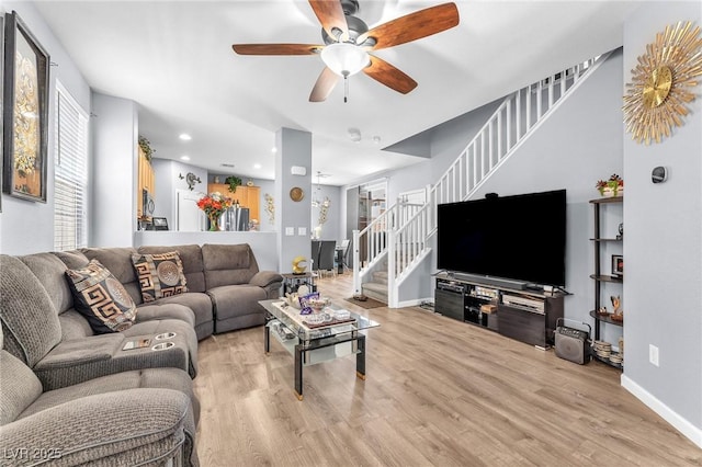 7115 Hickory Post Ave, Las Vegas, NV 89179 - living room featuring stairway, ceiling fan, light wood-style floors, baseboards, and recessed lighting