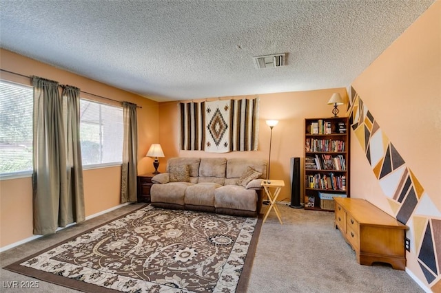 carpeted living room featuring a textured ceiling