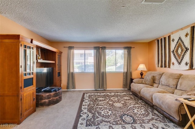 living room featuring light colored carpet and a textured ceiling
