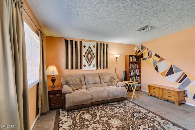 living room with carpet flooring, healthy amount of natural light, and a textured ceiling