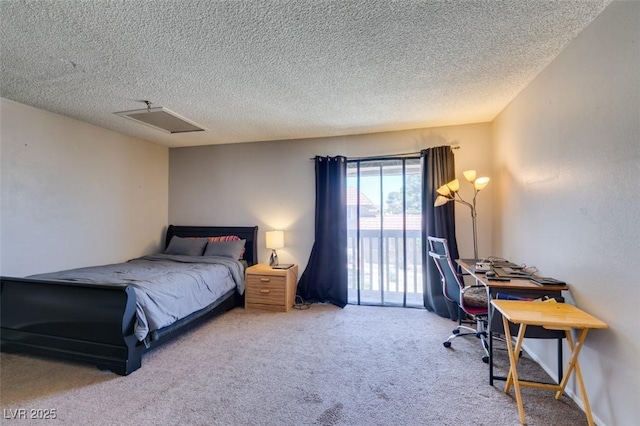 carpeted bedroom featuring access to exterior, a textured ceiling, and an office area