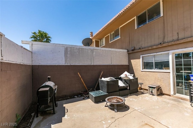 view of patio / terrace featuring a fire pit and fence