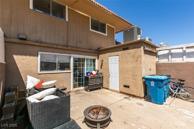 back of property with an outdoor fire pit, a patio, stucco siding, and fence