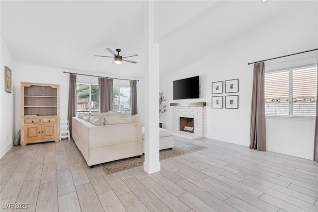 325 Heather Dr, Henderson, NV 89002 - living area featuring ceiling fan, light wood finished floors, a brick fireplace, baseboards, and high vaulted ceiling