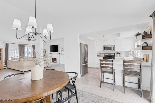 325 Heather Dr, Henderson, NV 89002 - dining area featuring a chandelier and light wood-style flooring