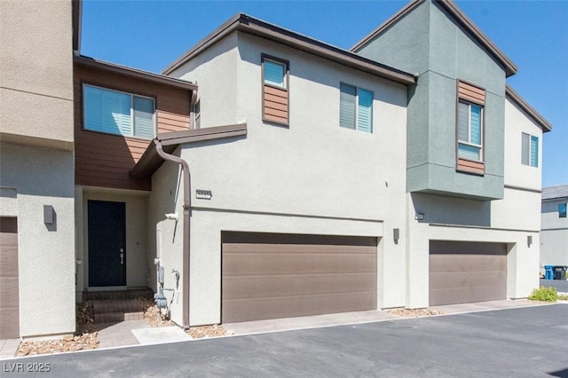 6145 May River St, Las Vegas, NV 89148 - view of front facade featuring stucco siding, an attached garage, and asphalt driveway