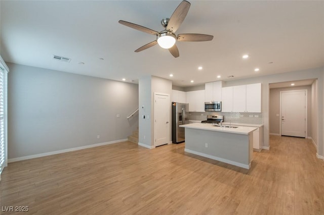 6145 May River St, Las Vegas, NV 89148 - kitchen with appliances with stainless steel finishes, a sink, a ceiling fan, a center island with sink, and white cabinets