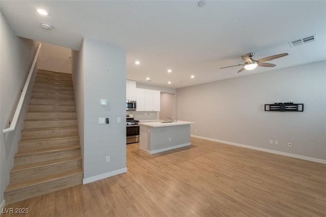 6145 May River St, Las Vegas, NV 89148 - kitchen featuring stainless steel appliances, open floor plan, ceiling fan, light wood-type flooring, and recessed lighting