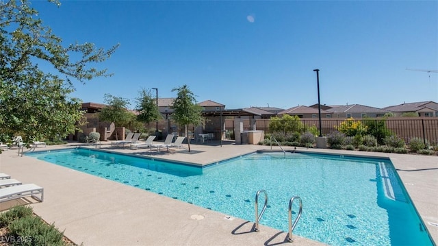 6145 May River St, Las Vegas, NV 89148 - community pool featuring a patio area, fence, and a residential view