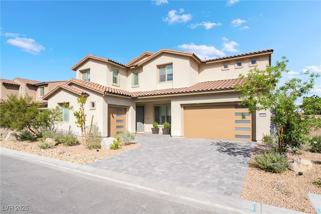 212 Harris Peak St, Las Vegas, NV 89138 - mediterranean / spanish-style house featuring stucco siding, an attached garage, decorative driveway, and a tile roof