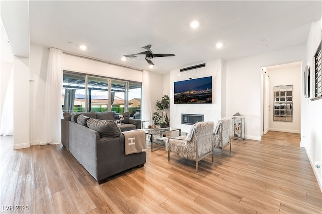 212 Harris Peak St, Las Vegas, NV 89138 - living area with light wood-type flooring, ceiling fan, recessed lighting, and a fireplace