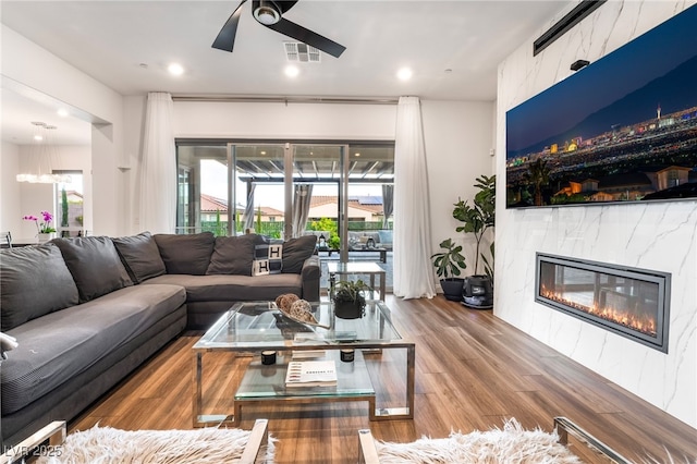 212 Harris Peak St, Las Vegas, NV 89138 - living room featuring a ceiling fan, a fireplace, wood finished floors, and recessed lighting