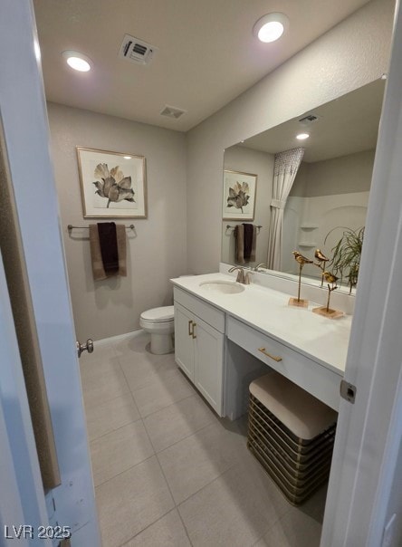 bathroom with vanity, toilet, tile patterned floors, and baseboards