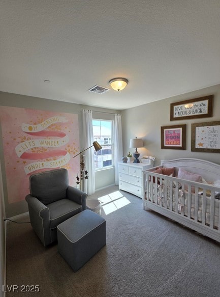 bedroom featuring carpet floors and a nursery area
