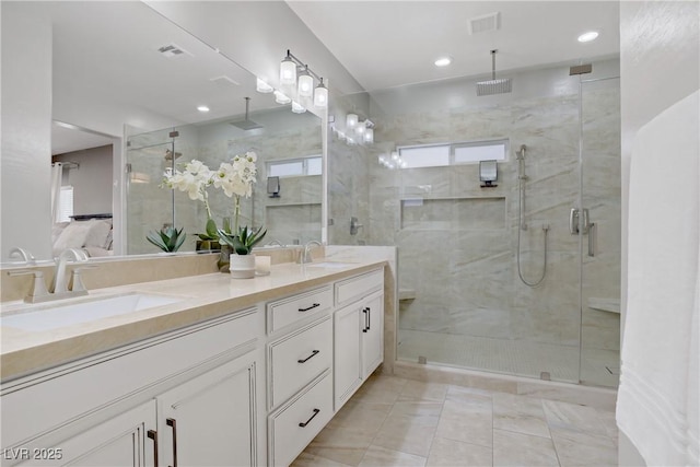 bathroom with a stall shower, plenty of natural light, double vanity, and recessed lighting