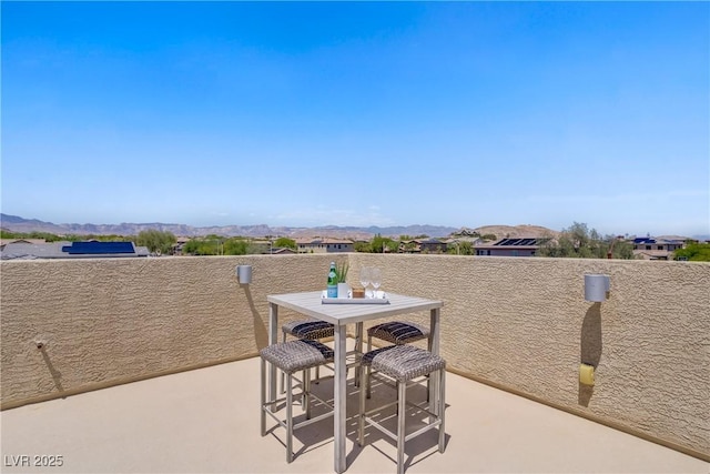view of patio featuring outdoor dining area and a mountain view