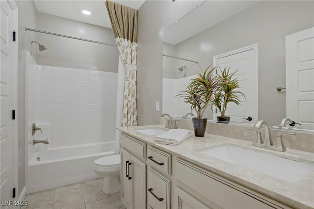 bathroom with shower / tub combo, toilet, and double vanity